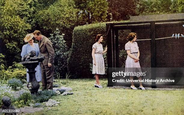 Colour photograph of King George VI , the Queen Mother , Queen Elizabeth II and Princess Margaret in the gardens of Windsor Castle. Dated 20th...