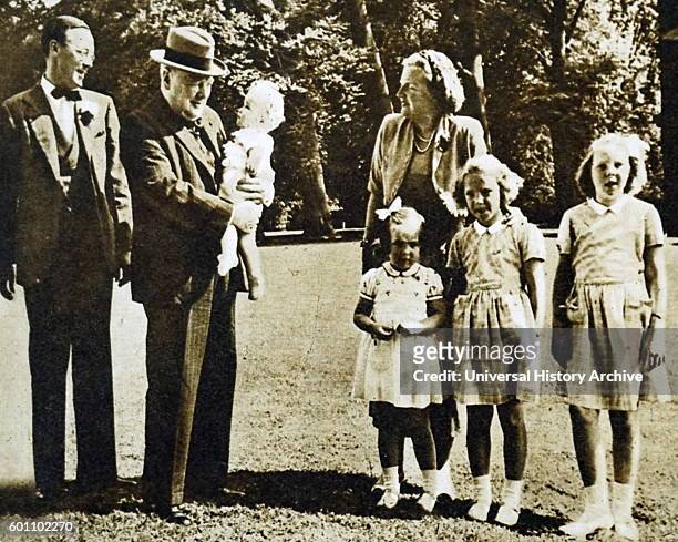 British former Prime Minister Winston Churchill holds his goddaughter Marijke in the grounds of Soestdijk Palace, during a visit to the Dutch Royal...