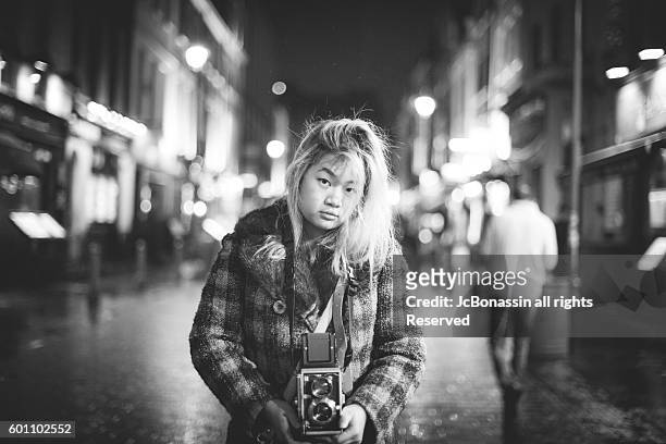 indonesian woman with a camera - jc bonassin stock-fotos und bilder