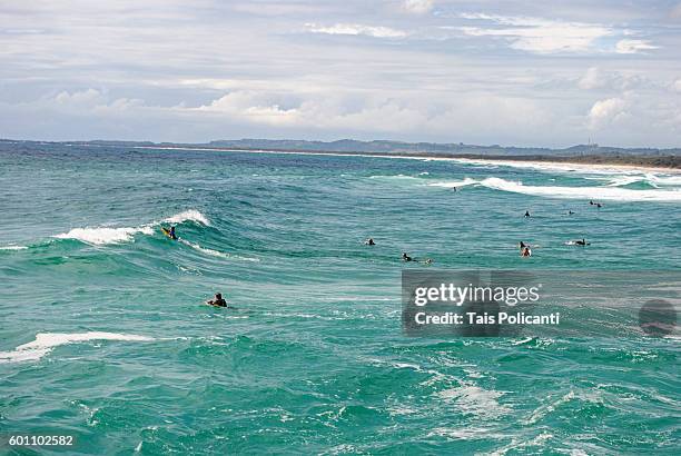 surfers in the waves at brunswick heads, new south wales, australia, oceania - brunswick heads nsw stock pictures, royalty-free photos & images