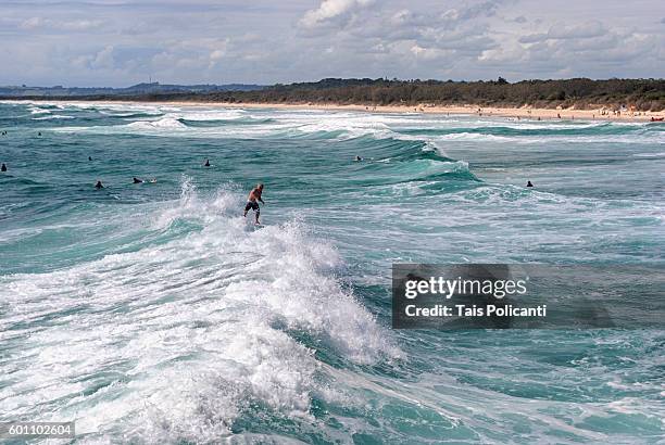 surfers in the waves at brunswick heads, new south wales, australia, oceania - brunswick heads nsw stock pictures, royalty-free photos & images