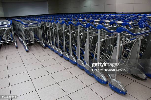 rows of baggage carts. - tambo international airport stock pictures, royalty-free photos & images