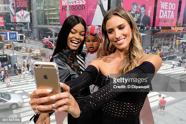 Teyana Taylor, daughter Iman "Junie" Shumpert, and Renee Bargh pose for a selfie during their visit to "Extra" at their New York studios at H&M in...