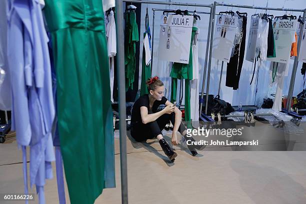 Models prepare backstage during the Milly Fashion Show during September 2016 New York Fashion Week at ArtBeam on September 9, 2016 in New York City.