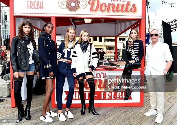 Model Gigi Hadid and fashion designer Tommy Hilfiger pose with models during the #TOMMYNOW Women's Fashion Show during New York Fashion Week at Pier...