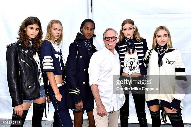 Fashion designer Tommy Hilfiger and model Gigi Hadid pose with models backstage at the #TOMMYNOW Women's Fashion Show during New York Fashion Week at...