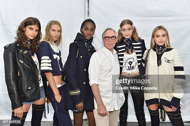 Fashion designer Tommy Hilfiger and model Gigi Hadid pose with models backstage at the #TOMMYNOW Women's Fashion Show during New York Fashion Week at...