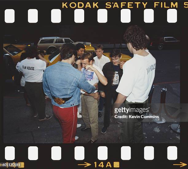 Members of British rock group New Order are checked by security staff, New York, July 1983. Centre, left to right: bassist Peter Hook,...