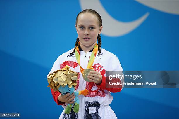 Gold medalist Ellie Robinson of Great Britain celebrates on the podium at the medal ceremony for the Women's 50m Butterfly - S6 on day 2 of the Rio...