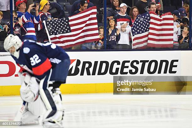 Fans display the American flag during warmups prior to an exhibition game between Team USA and Team Canada on September 9, 2016 at Nationwide Arena...