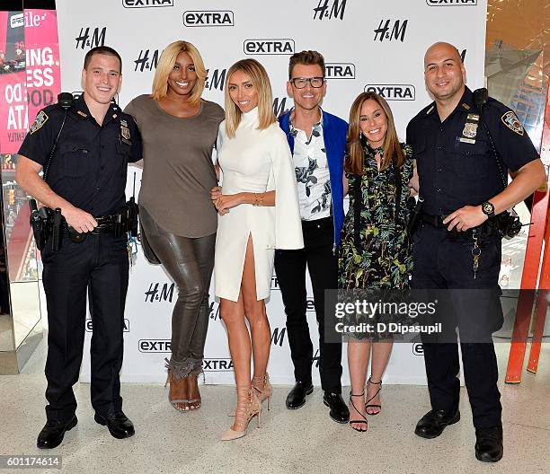 NeNe Leakes, Giuliana Rancic, Brad Goreski, and Melissa Rivers pose with NYPD officers Octavio Diaz and Chris Martinez during their visit to "Extra"...