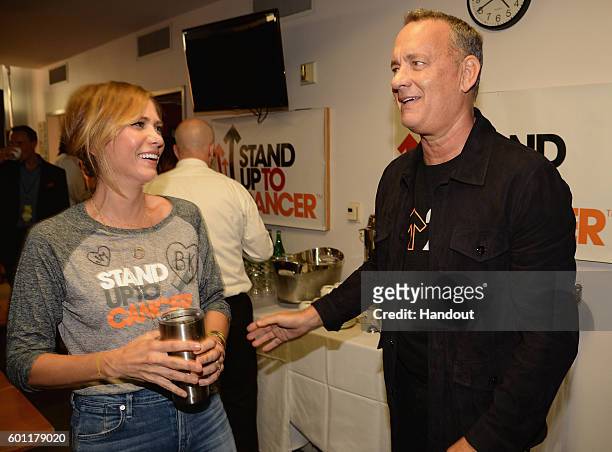 In this handout photo provided by American Broadcasting Companies Inc, actors Kristen Wiig and Tom Hanks attend Stand Up To Cancer , a program of the...