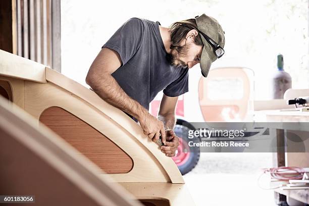 an adult, male carpenter working with tools in his wood shop - robb reece stock pictures, royalty-free photos & images