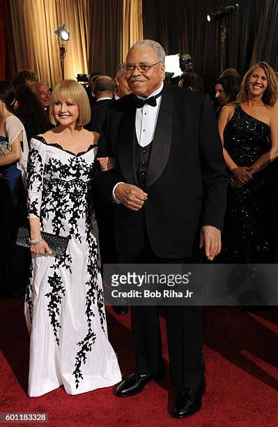Portrait of married actors Cecilia Hart and James Earl Jones as they pose together on the red carpet at the Hollywood & Highland Center Theatre...