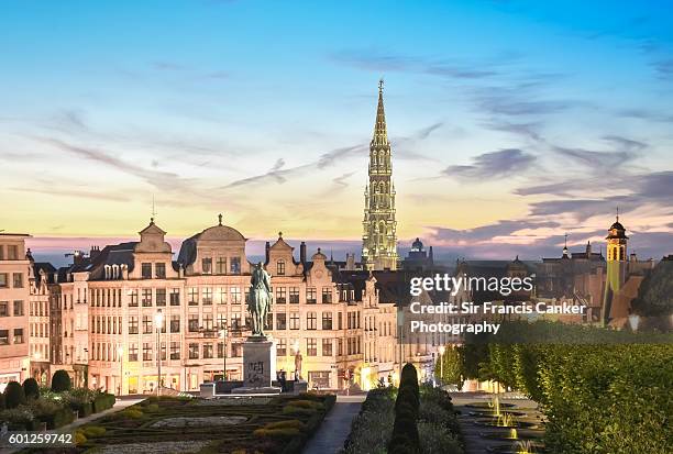 brussels skyline at dusk with majestic city hall bell tower in gothic style illuminated with romantic sky, brussels, belgium - グランプラス ストックフォトと画像