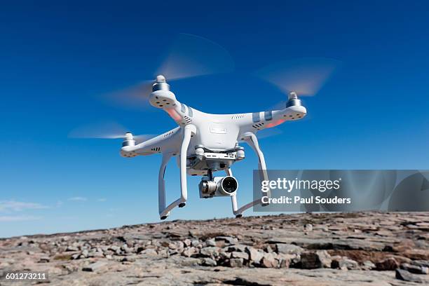 hovering drone, nunavut territory, canada - drones stock pictures, royalty-free photos & images