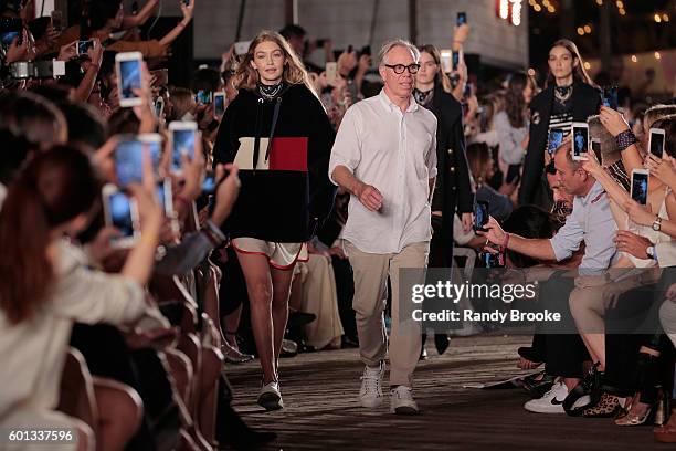 Model Gigi Hadid and designer Tommy Hilfiger walk the runway at #TOMMYNOW Women's Fashion Show during New York Fashion Week at Pier 16 on September...