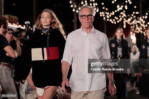 Model Gigi Hadid and designer Tommy Hilfiger walk the runway at #TOMMYNOW Women's Fashion Show during New York Fashion Week at Pier 16 on September...