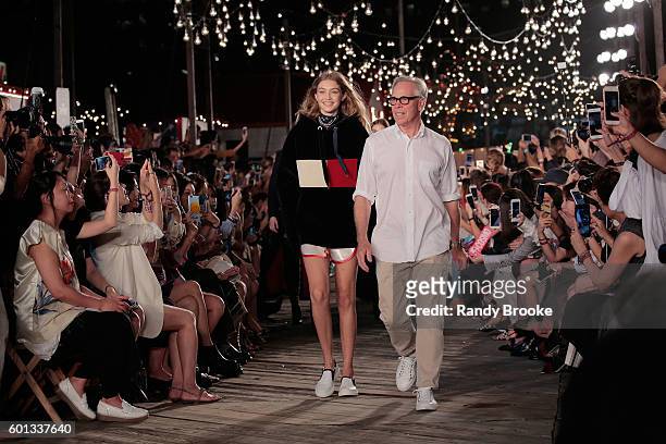 Model Gigi Hadid and designer Tommy Hilfiger walk the runway at #TOMMYNOW Women's Fashion Show during New York Fashion Week at Pier 16 on September...