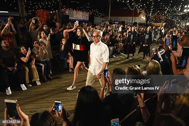 Model Gigi Hadid and Designer Tommy Hilfiger walk the runway at the #TOMMYNOW Women's Fashion Show during New York Fashion Week at Pier 16 on...