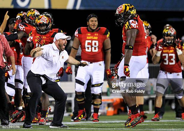Assistant athletic director of football sport performance Rick Court of the Maryland Terrapins celebrates after the Terrapins' defense makes a stop...