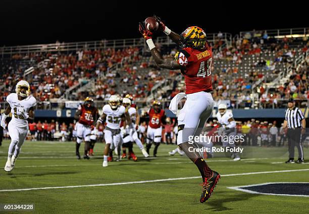 Derrick Hayward of the Maryland Terrapins scores a touchdown during the first half of the game against the FIU Panthers at FIU Stadium on September...