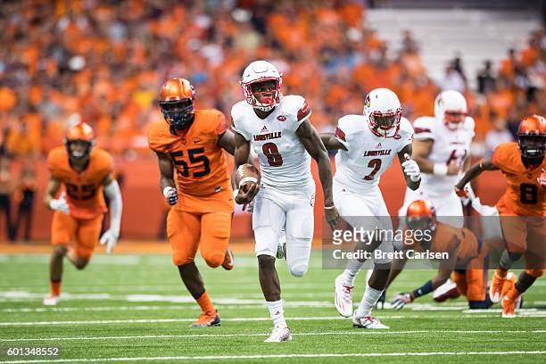 Lamar Jackson of the Louisville Cardinals carries the ball for a touchdown during the first half against the Syracuse Orange on September 9, 2016 at...