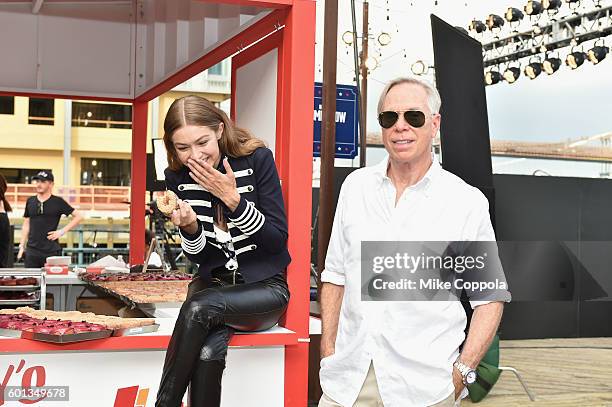 Model Gigi Hadid and fashion designer Tommy Hilfiger attend the #TOMMYNOW Women's Fashion Show during New York Fashion Week at Pier 16 on September...