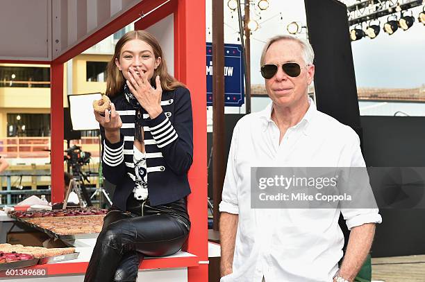 Model Gigi Hadid and fashion designer Tommy Hilfiger attend the #TOMMYNOW Women's Fashion Show during New York Fashion Week at Pier 16 on September...