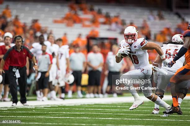 Cole Hikutini of the Louisville Cardinals runs with the ball after a reception during the second half against the Syracuse Orange on September 9,...