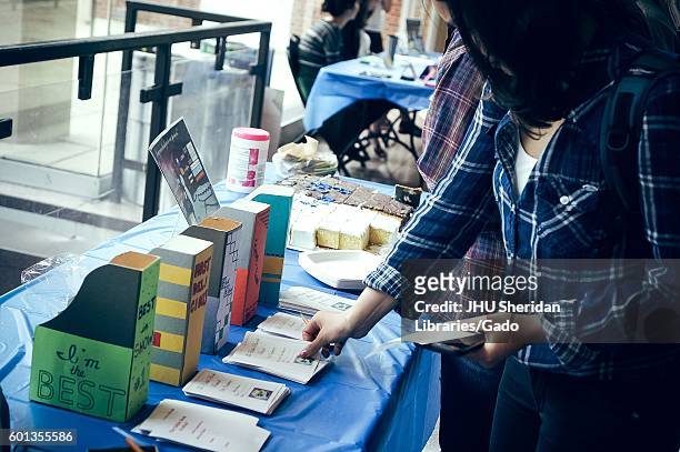 Undergraduate college students vote on the best cakes during the Johns Hopkins University's annual "Read It And Eat It" Edible Book Festival on the...