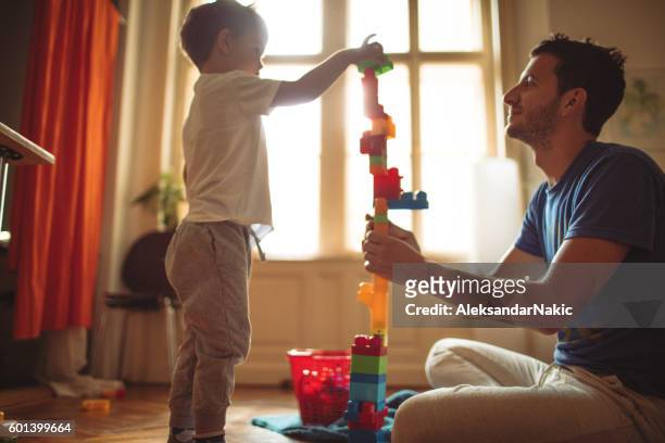 building a castle with my dad - child and blocks stock pictures, royalty-free photos & images
