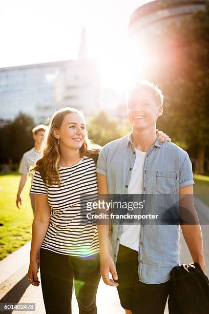 happiness multiracial friends embraced togetherness in london - sun flare couple stock pictures, royalty-free photos & images