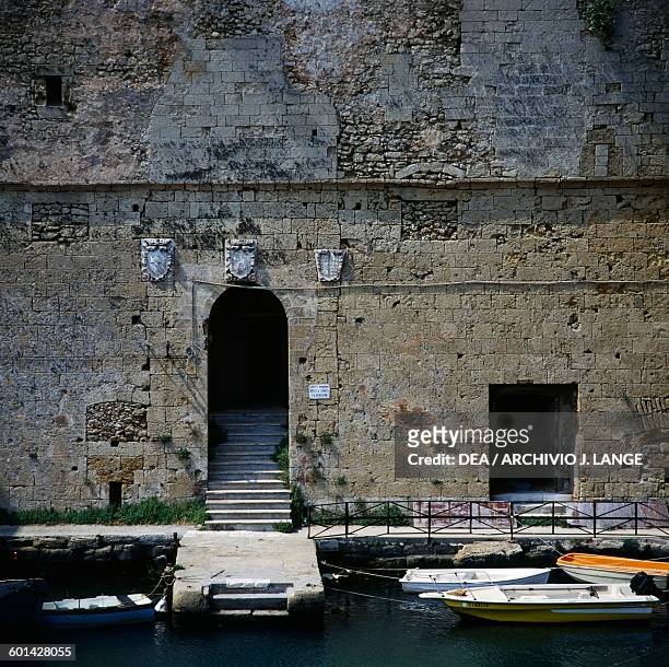 Entrance with coats of arms, Alfonsino castle, or Castello di Mare, Sant'Andrea island, Brindisi, Apulia. Italy, 16th century.