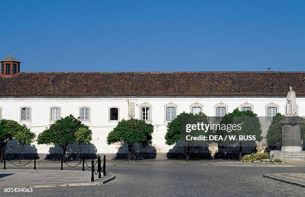 The Episcopal seminary and the statue of Bishop Francisco Gomes de Avelar , Faro, Faro district, Algarve, Portugal.