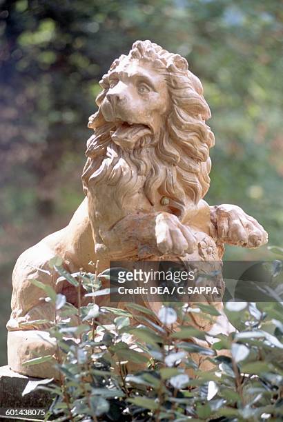 Lion, a small statue in the garden of Chateau d'Etchauz, Saint-Etienne-de-Baigorry, France, Aquitaine, 11th-16th century.