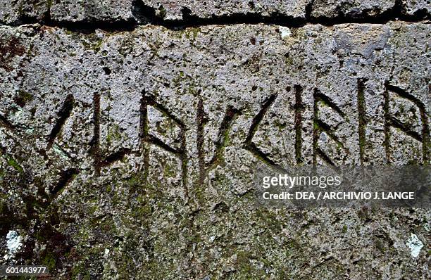 Inscription on the architrave above the entrance of a tomb, Etruscan necropolis of the Crocifisso del Tufo, Orvieto, Umbria, Italy. Etruscan...