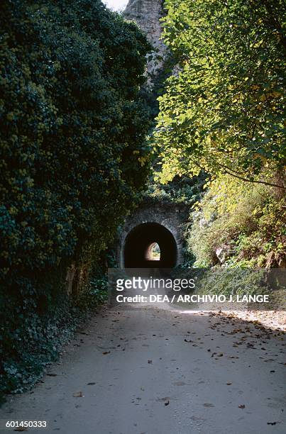 Road and tunnel access to the Rocky Necropolis of Pantalica, Pantalica Nature Reserve, Cava Grande torrent valley and the Anapo river valley, Sicily,...
