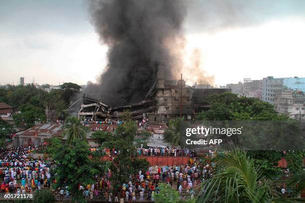 Smoke and flames billow from a burning garment factory in Tongi, the key Bangladeshi garment manufacturing hub of Gazipur, on the outskirts of Dhaka...