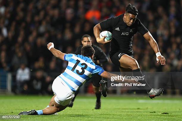 Julian Savea of the All Blacks breaks through the tackle of Matias Orlando of Argentina to score a try during the Rugby Championship match between...