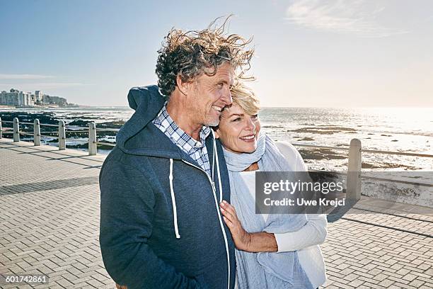 happy mature couple on promenade - cape town waterfront stock pictures, royalty-free photos & images