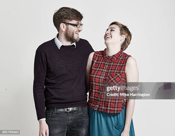 portrait of young couple laughing - friends with white background stockfoto's en -beelden