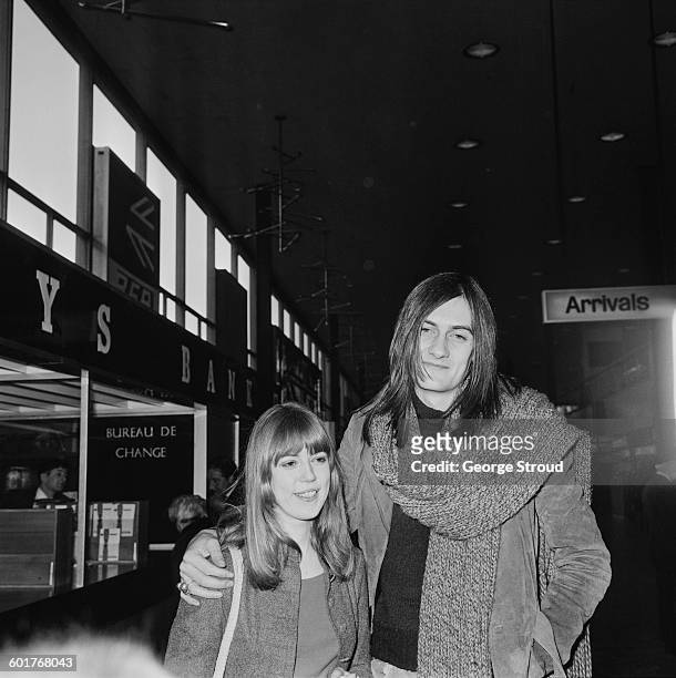 British musician Mick Fleetwood of Fleetwood Mac with his girlfriend, model Jenny Boyd at London Airport, UK, 17th February 1970. The couple were...