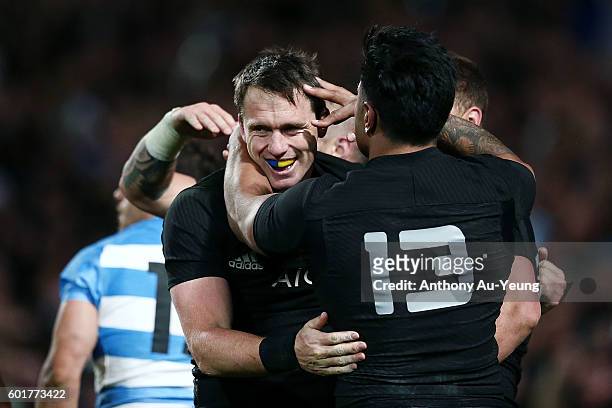Ben Smith of New Zealand is mobbed by teammates after scoring a try during the Rugby Championship match between the New Zealand All Blacks and...