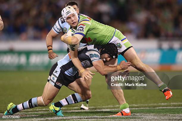 Jarrod Croker of the Raiders is tackled during the NRL Qualifying Final match between the Canberra Raiders and the Cronulla Sharks at GIO Stadium on...