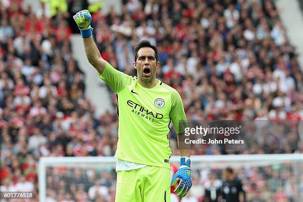 Claudio Bravo of Manchester City celebrates his team's first goal during the Premier League match between Manchester United and Manchester City at...