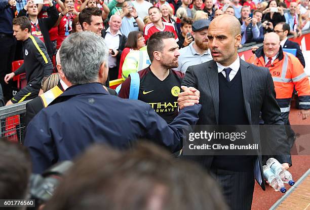 Manchester United manager Jose Mourinho shakes hands with Manchester City manager Pep Guardiola prior to the Premier League match between Manchester...