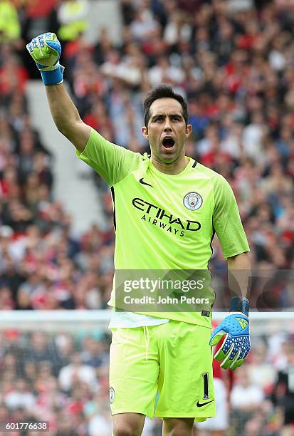 Claudio Bravo of Manchester City celebrates his team's first goal during the Premier League match between Manchester United and Manchester City at...