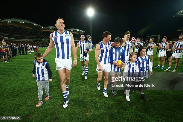 Kangaroo players who will not play for the club next year, come from the field after the AFL 1st Elimination Final match between the Adelaide Crows...