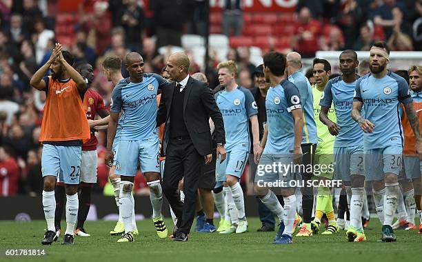 Manchester City's Spanish manager Pep Guardiola and his players celebrate on the pitch after the English Premier League football match between...